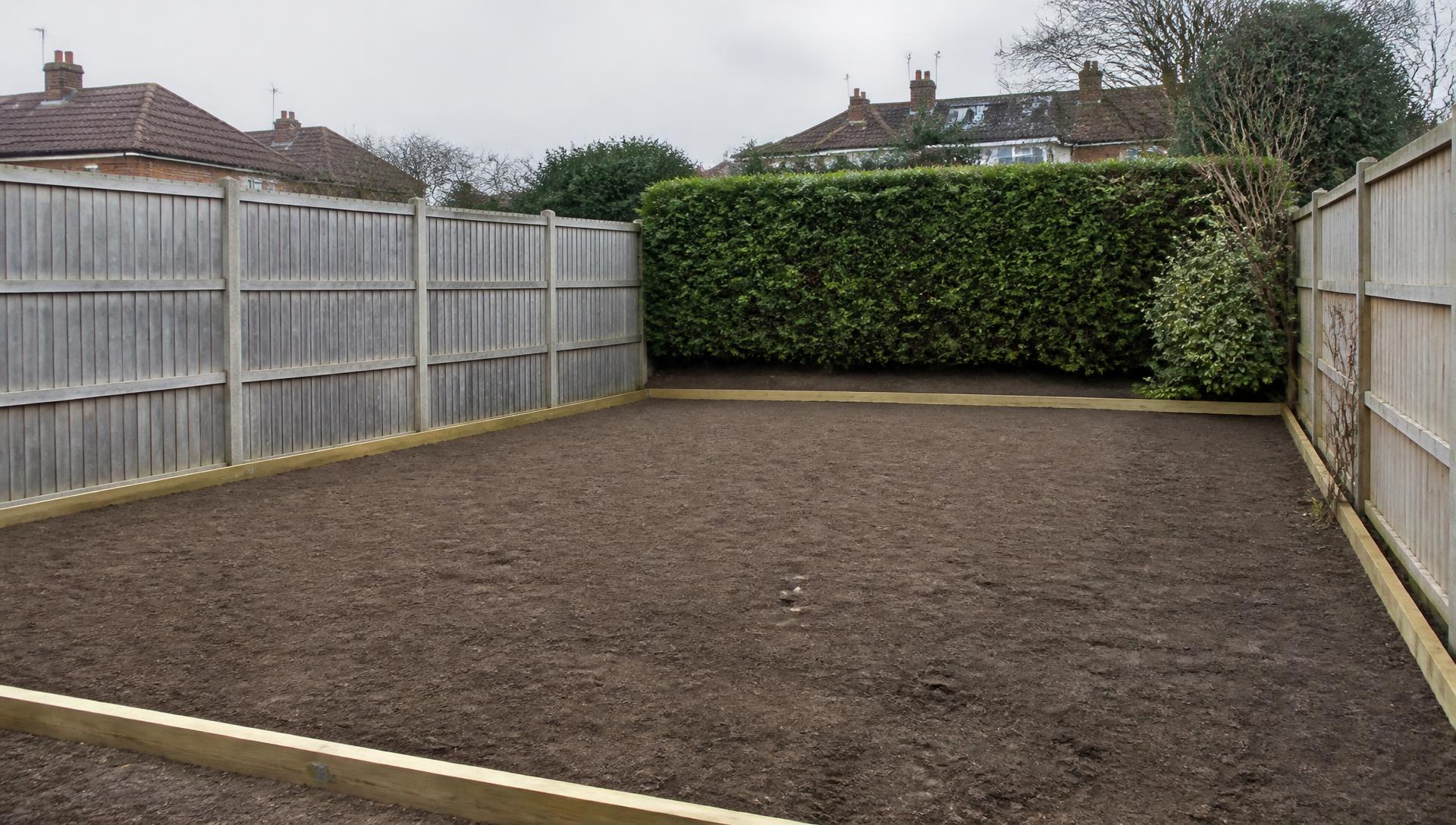 Domestic back garden stripped and levelled with new timber edging ready for landscaping